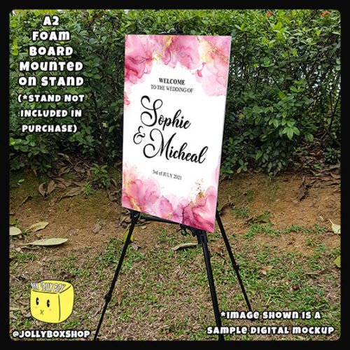 Digital mockup of a A2 Size Pink and Gold Splashes theme welcome to wedding board Placed on Stand