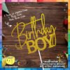 Digital mockup of a fixed design with text Birthday Boy cake topper placed on a table