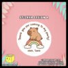 Digital-Mockup-of-Cute-Capybara-sitting-on-a-small-rainbow-Theme-Sticker-Design-A Digital mockup of a cute capybara round sticker design A