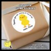 Sample-of-Cute-Happy-Duck-Sticker-Design-E-Pasted-on-Gift-Box-with-text Digital mockup of a cute duck round sticker design E pasted on gift box